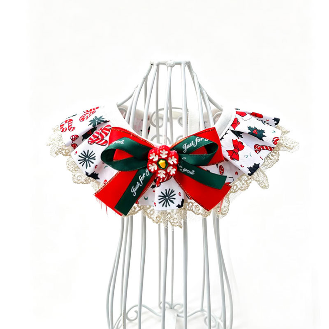 White pet neckwear with candy cane and holly motifs, lace-look edging and a red and green bow.