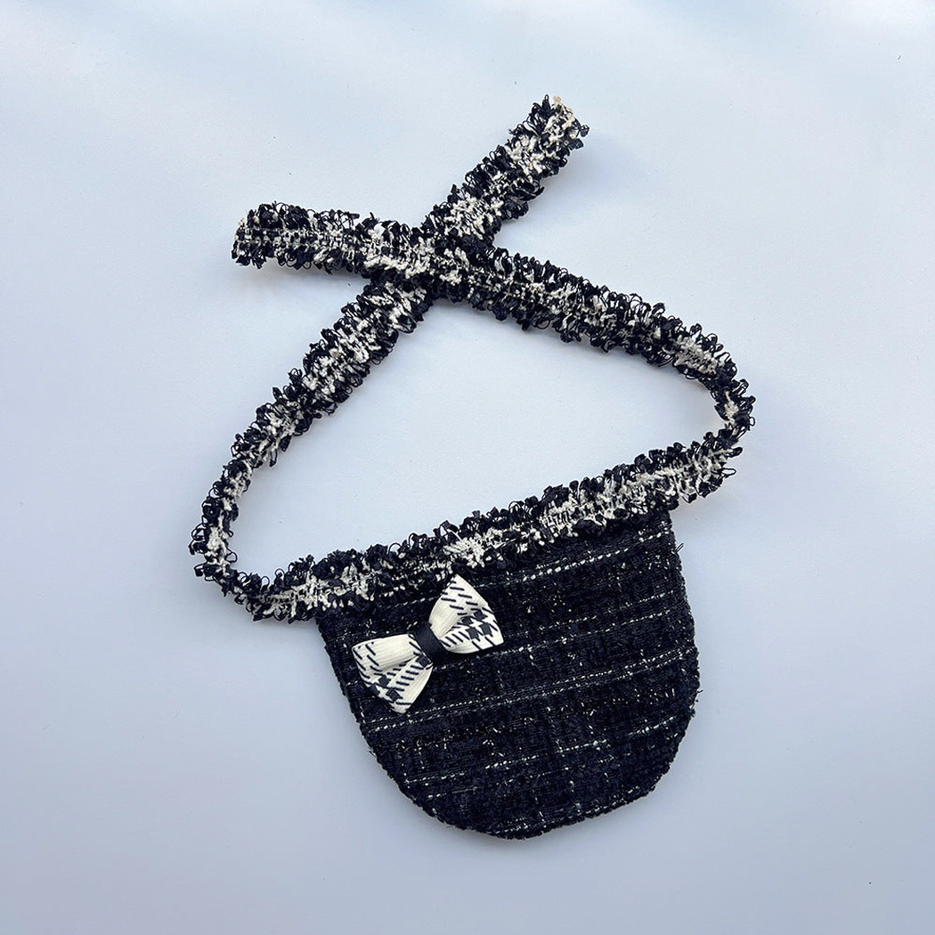 Black Grid Pet Neckwear with a rounded bib, black-and-white geometric bow, and textured neck ties.