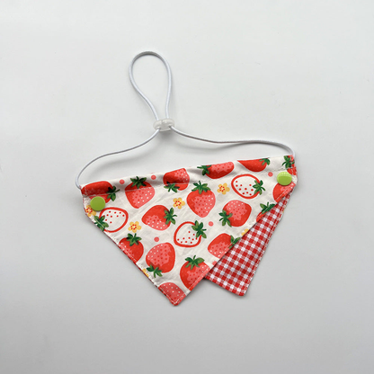 Red Bib Pet Neckwear with strawberry print, a red gingham lower panel, green snaps and a white cord loop.