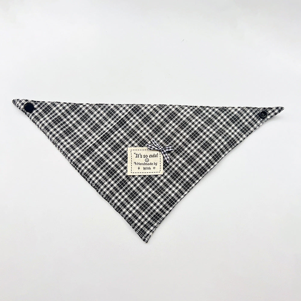 Black Bandana pet neckwear spread flat with white checks, corner snaps and a small bow beside a square label.