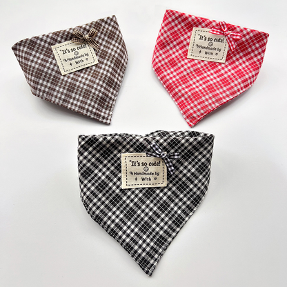 Brown, red and black checked bandana-style pet neckwear in curved shapes with small bows and square labels.