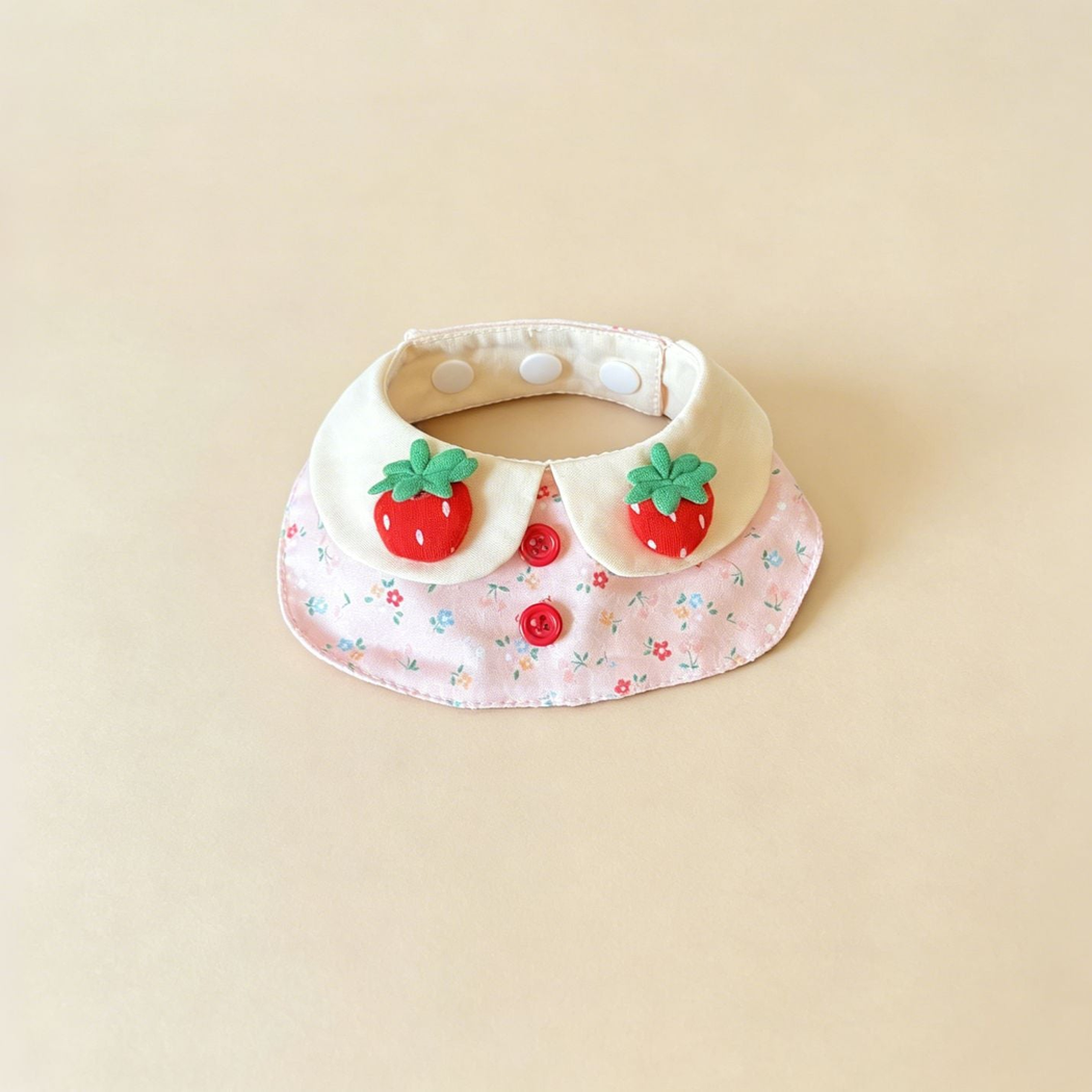 Pink Floral pet neckwear with ivory neck panels, strawberry decorations and two red front buttons.