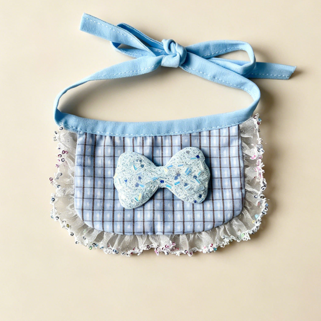 Blue Sparkle Pet Neckwear with a checked bib panel, glittery bow, ruffled border and blue ties.