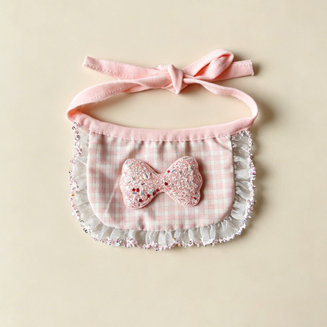Pink Sparkle Pet Neckwear with a checked bib panel, glittery bow, ruffled border and pink ties.