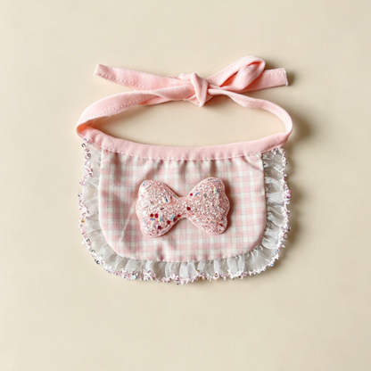 Pink Sparkle Pet Neckwear with a checked bib panel, glittery bow, ruffled border and pink ties.