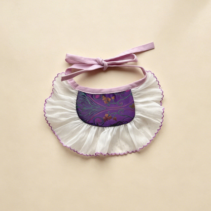 Purple Wide pet neckwear with curling floral motifs, a broad white ruffle and mauve bow ties.
