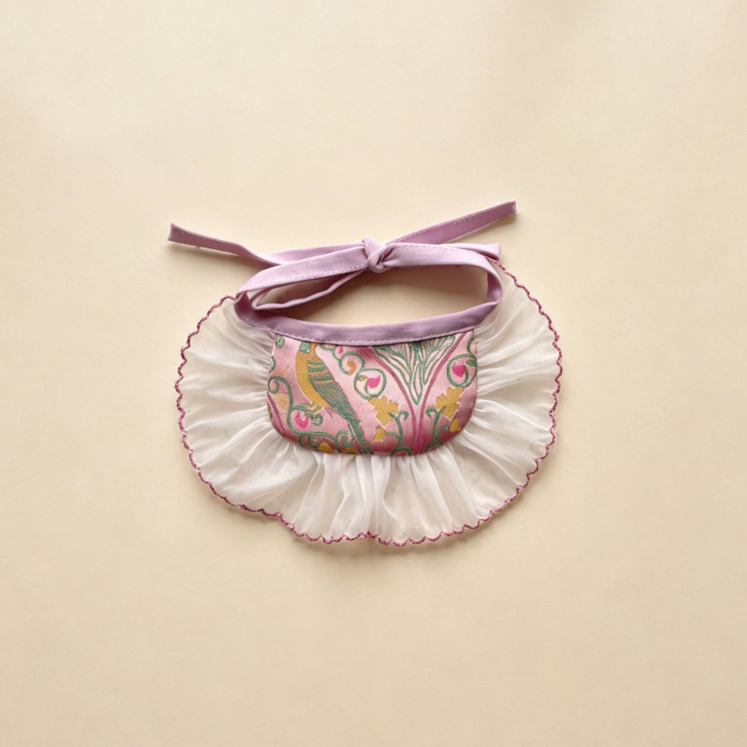 Pink Wide pet neckwear with a bird and floral pattern, broad white ruffle and bow ties.