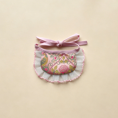 Pink Narrow pet neckwear with a floral patterned bib, narrow white ruffle and bow ties.