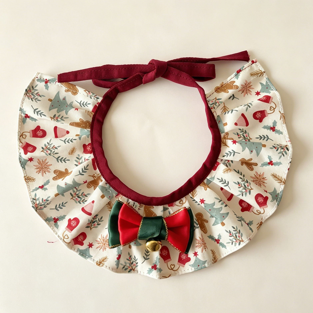 Gingerbread Ruffle Pet Neckwear with ivory patterned pleats, burgundy ties, red and green bow and gold-tone bell.