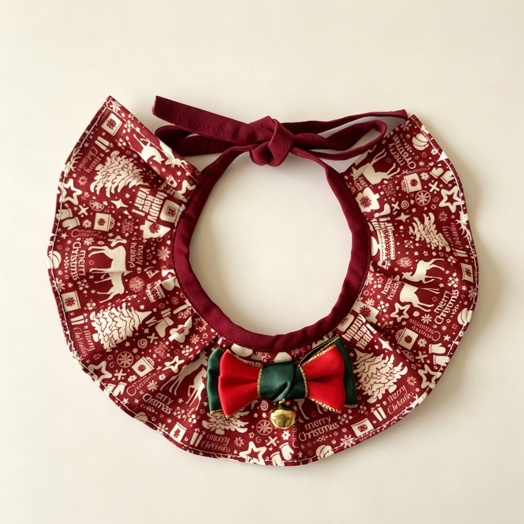 Reindeer Ruffle Pet Neckwear with burgundy and ivory print, red and green bow and gold-tone bell.