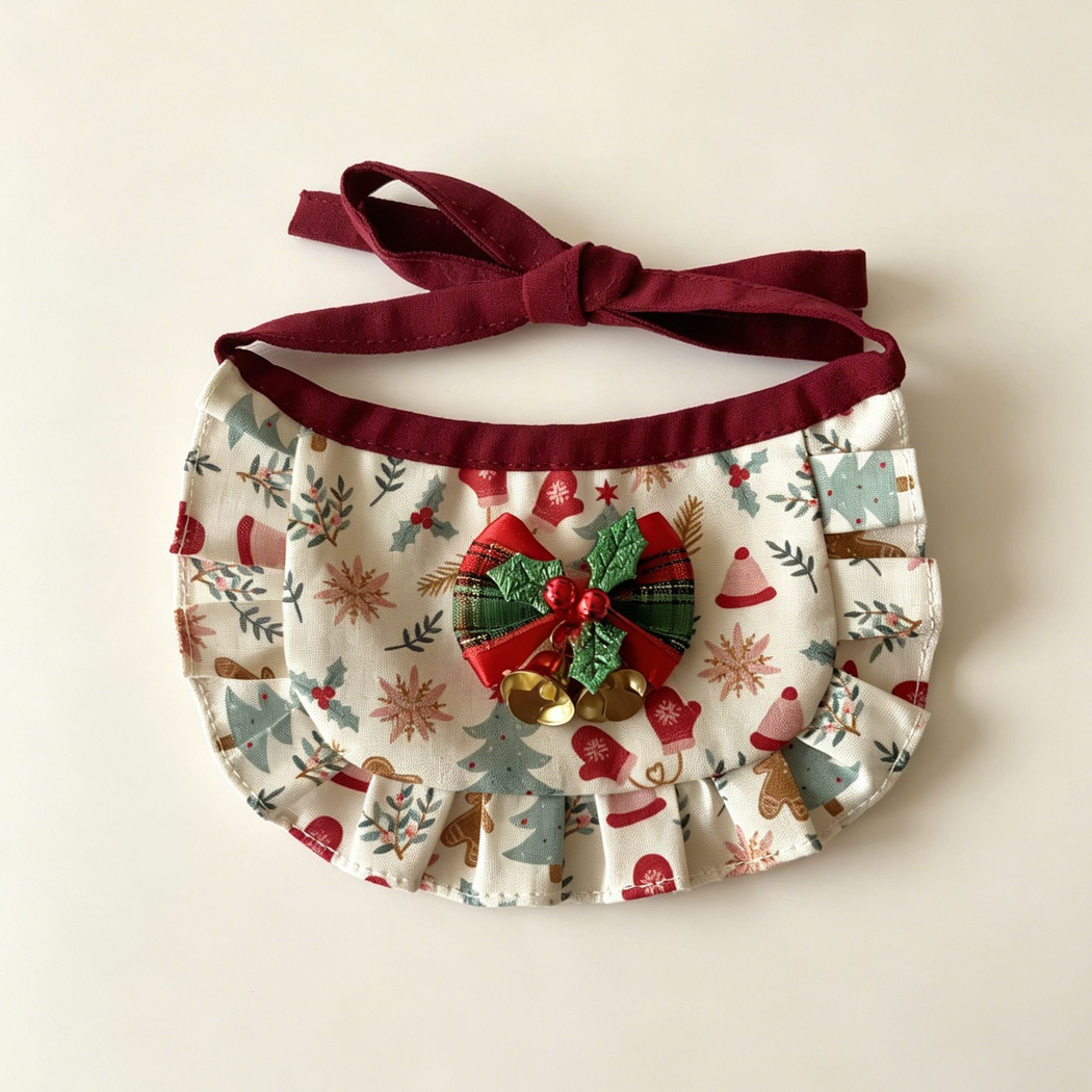 Gingerbread Bib Pet Neckwear with ivory patterned panel, ruffled border, holly-decorated bow and two gold-tone bells.