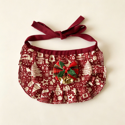 Reindeer Bib Pet Neckwear with burgundy patterned panel, ruffled border, holly-decorated bow and two gold-tone bells.