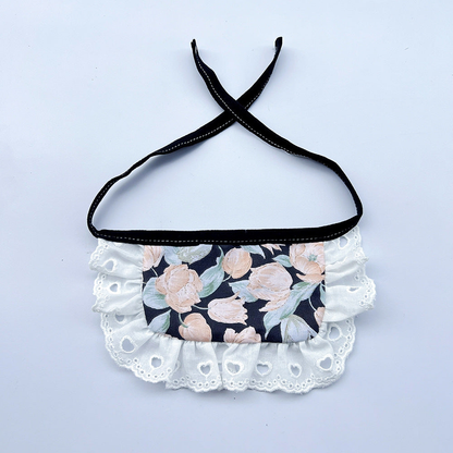 Wide floral Pet Neckwear with black ties and white ruffles featuring heart-shaped eyelets.