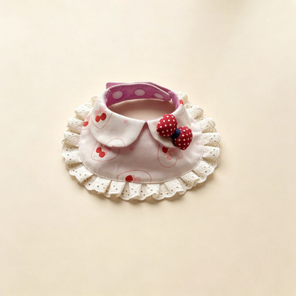 Cherries pet neckwear in light pink with outlined hearts, ivory lace ruffles and a red dotted bow.