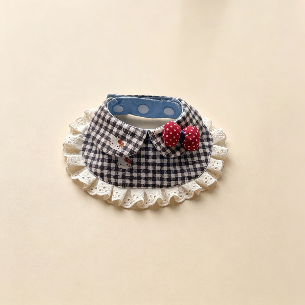 Gingham pet neckwear with black and white checks, small cat motifs, ivory lace ruffles and a red dotted bow.