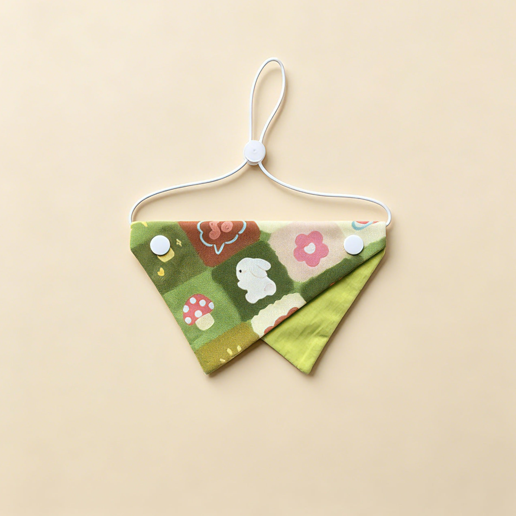 Green Rabbit Pet Neckwear with rabbit, flower and mushroom motifs, green underpanel and white cord.