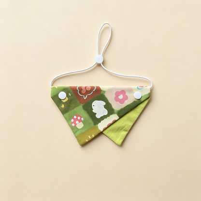 Green Rabbit Pet Neckwear with rabbit, flower and mushroom motifs, green underpanel and white cord.