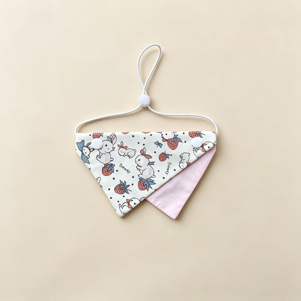 Pink Rabbit Pet Neckwear with rabbit and strawberry print, pale pink underpanel and white cord.