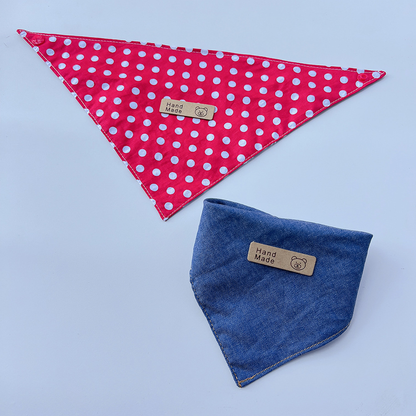 Red pet neckwear with white polka dots spread flat beside folded Blue pet neckwear.