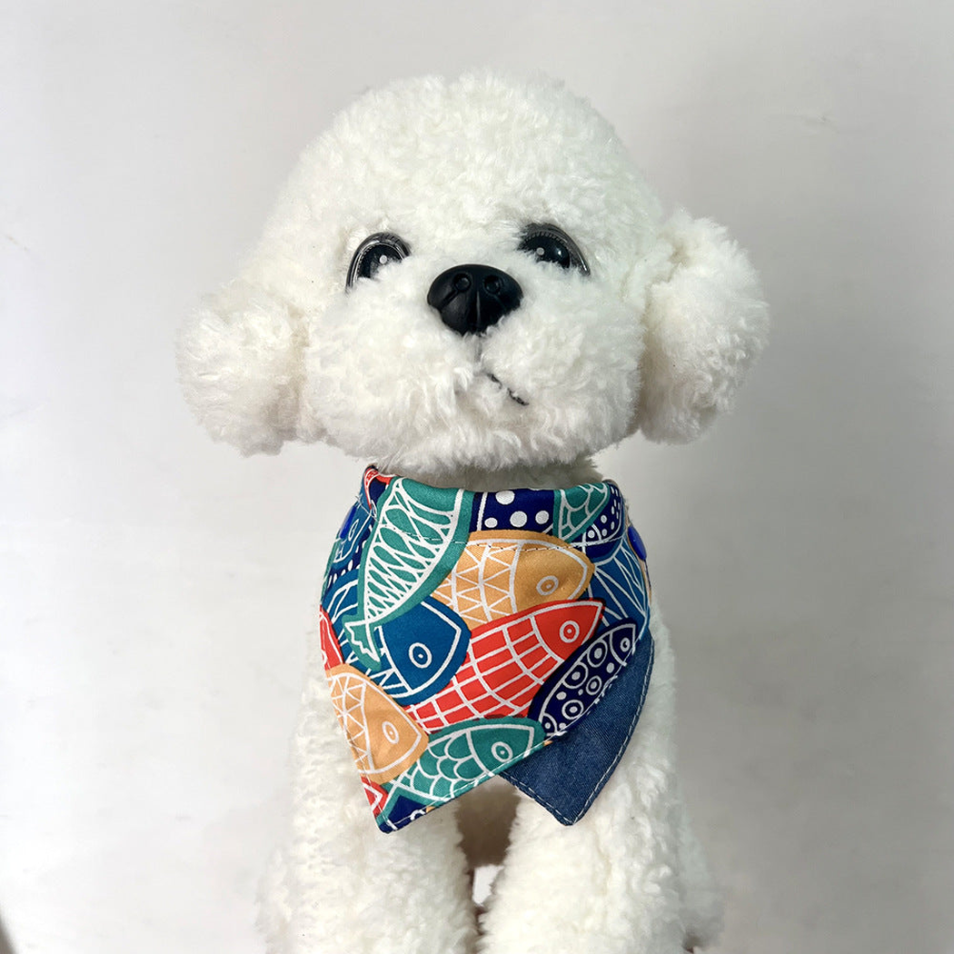 White plush dog wearing Multicolor Bib pet neckwear with a dark blue inner panel