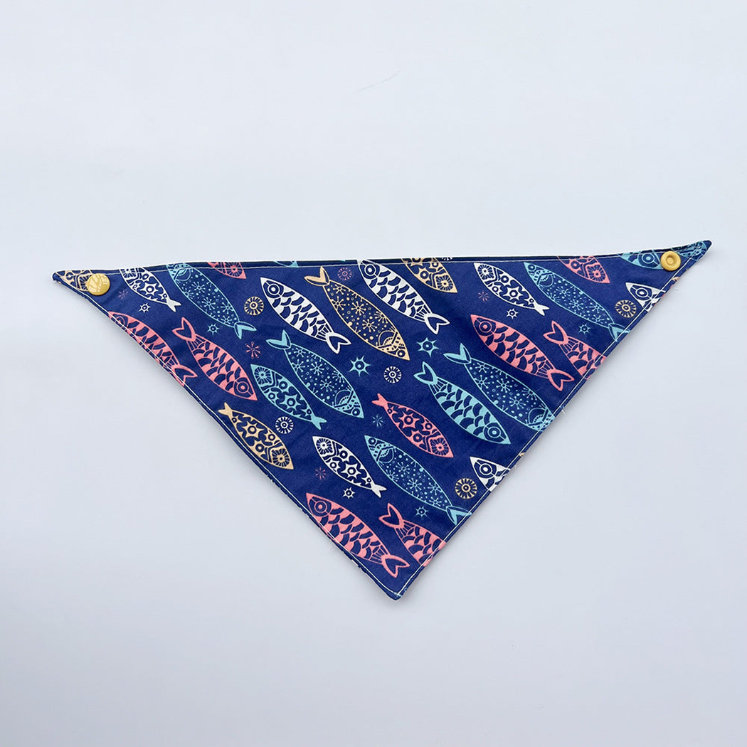Navy Bandana pet neckwear spread flat with colorful fish motifs and yellow corner snaps