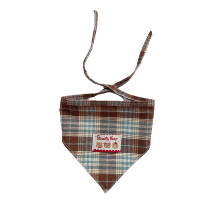 Brown plaid Pet Neckwear with a triangular front, bear patch, and extended ties on white.