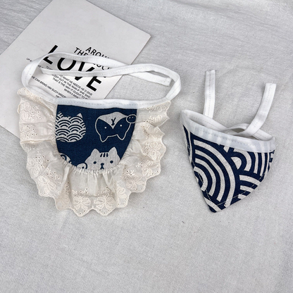 Navy pet neckwear with animal motifs and ivory ruffles beside a geometric triangular bandana.
