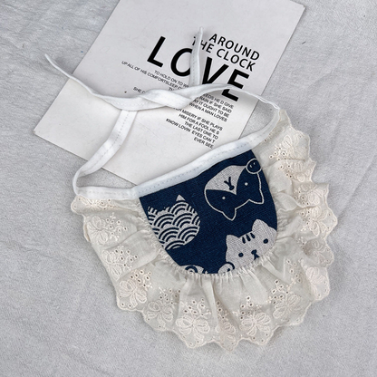 Animal Ruffle pet neckwear with navy animal-patterned panel, ivory eyelet-style ruffles and white ties.