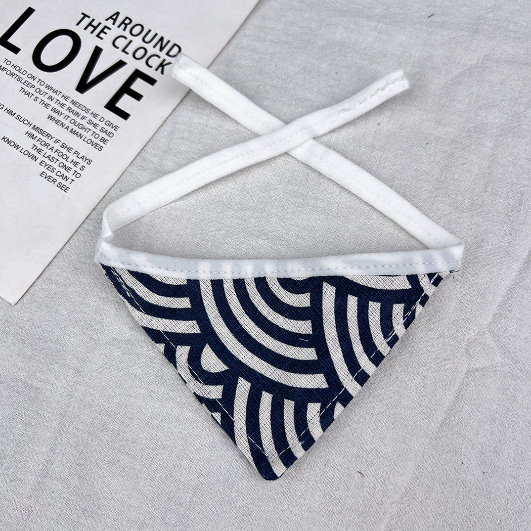Geometric Bandana pet neckwear with navy and ivory curved lines, triangular shape and white ties.