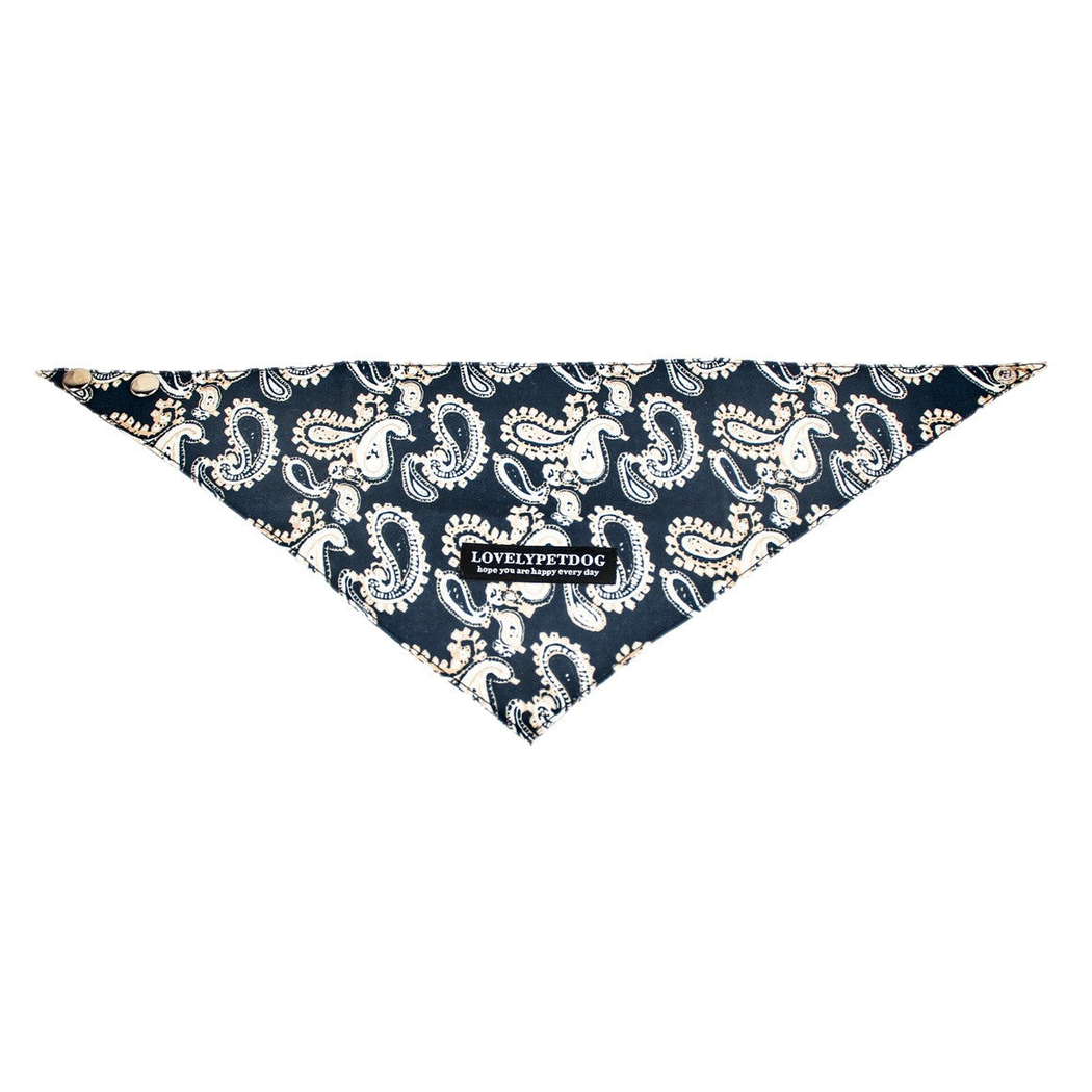 Navy triangular pet neckwear spread flat, with cream paisley motifs and snap fasteners.