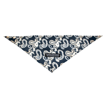 Navy triangular pet neckwear spread flat, with cream paisley motifs and snap fasteners.