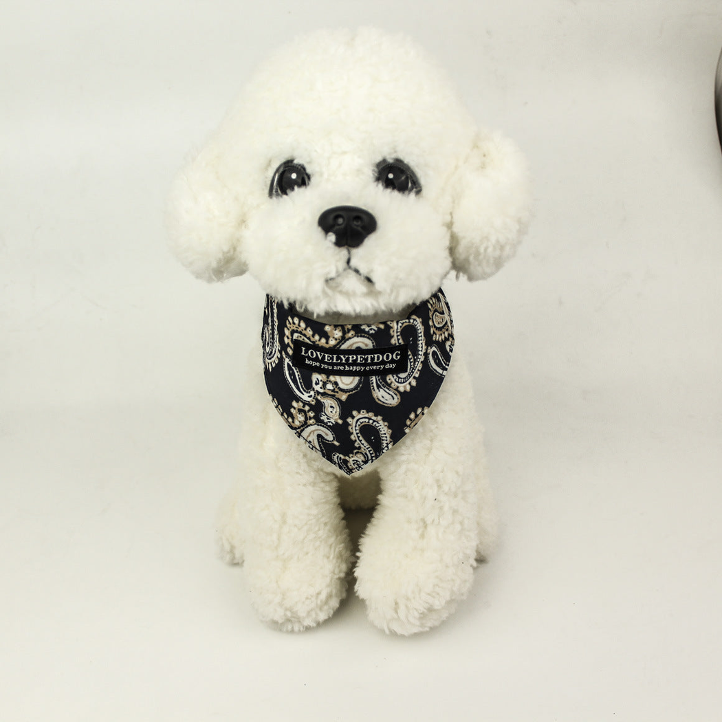 White dog mannequin wearing Navy paisley pet neckwear with a pointed front.