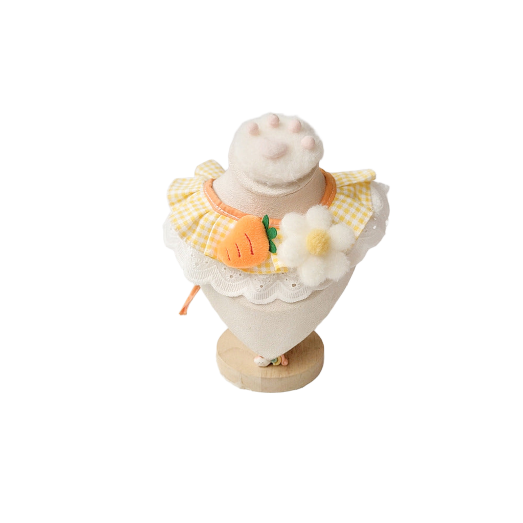 Carrot Pet Neckwear with yellow gingham, a carrot appliqué, and a white flower on a display stand.