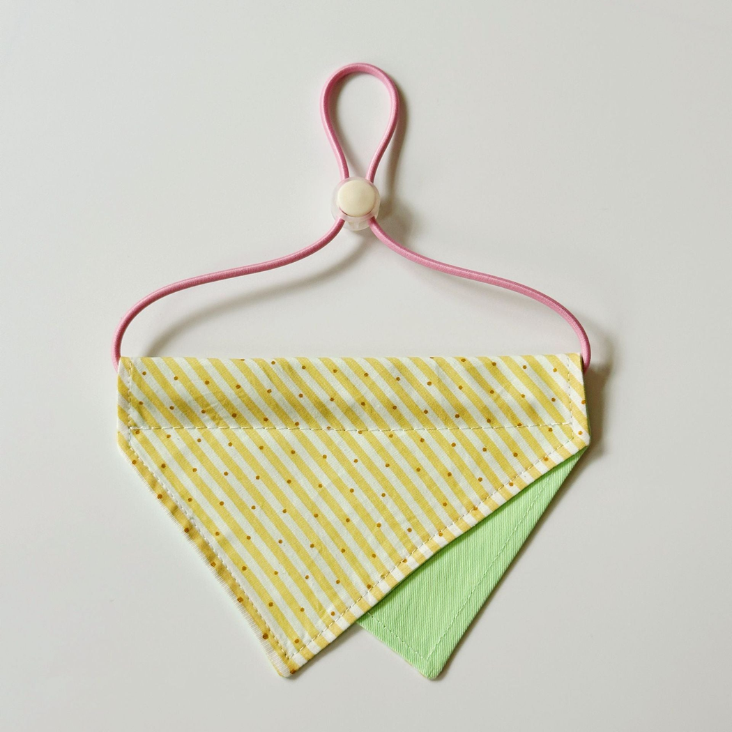 Yellow / Green Pet Neckwear with diagonal stripes, overlapping triangular panels and a pink neck loop.