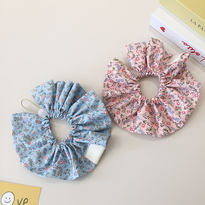 Reverse views of Light Blue and Light Pink floral ruffled pet neckwear with gathered openings.