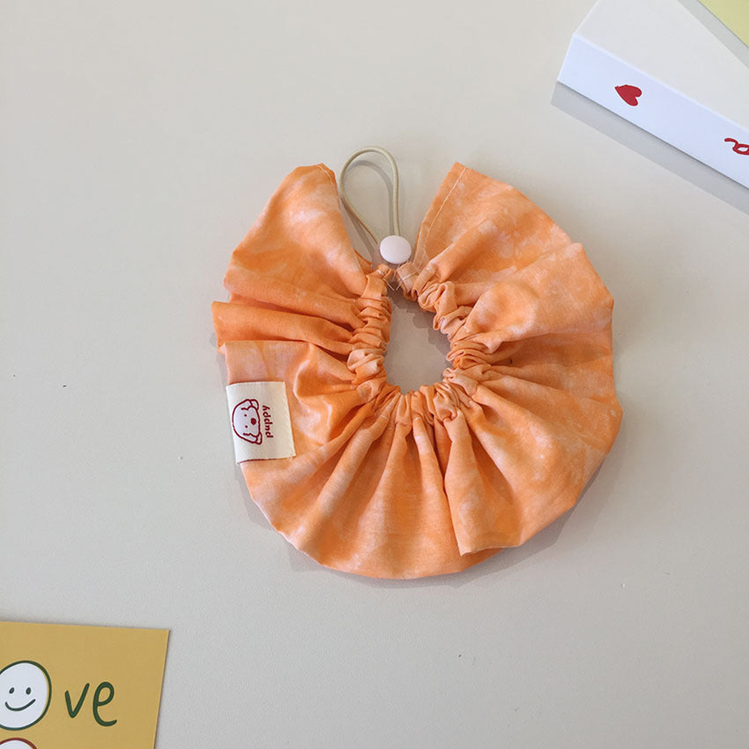 Orange pet neckwear with white clouded pattern and gathered circular ruffles.
