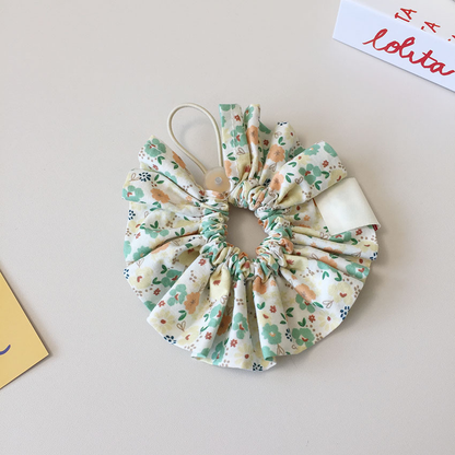 Reverse view of Yellow floral ruffled Pet Neckwear showing the gathered center, loop, and back of the tag.