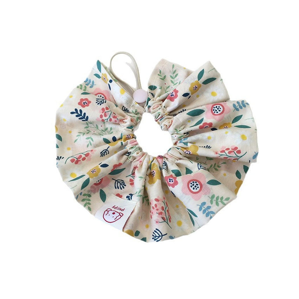 Ivory floral ruffled pet neckwear with a gathered opening and loop on a white background.