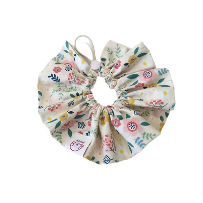 Ivory floral ruffled pet neckwear with a gathered opening and loop on a white background.