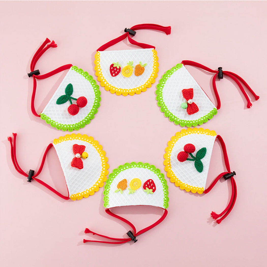 Pet Neckwear with green and yellow scalloped edges, cherry, fruit, and bow decorations arranged on pink.