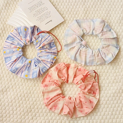 Bow, Floral, and Plaid ruffled Pet Neckwear arranged together on a cream background.