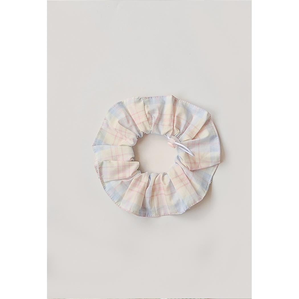 Pastel Plaid Pet Neckwear with a circular gathered ruffle, white loop cord, and pink toggle.