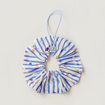 Blue ruffled pet neckwear with white stripes, multicolored dots, and a pale blue loop with round adjuster.