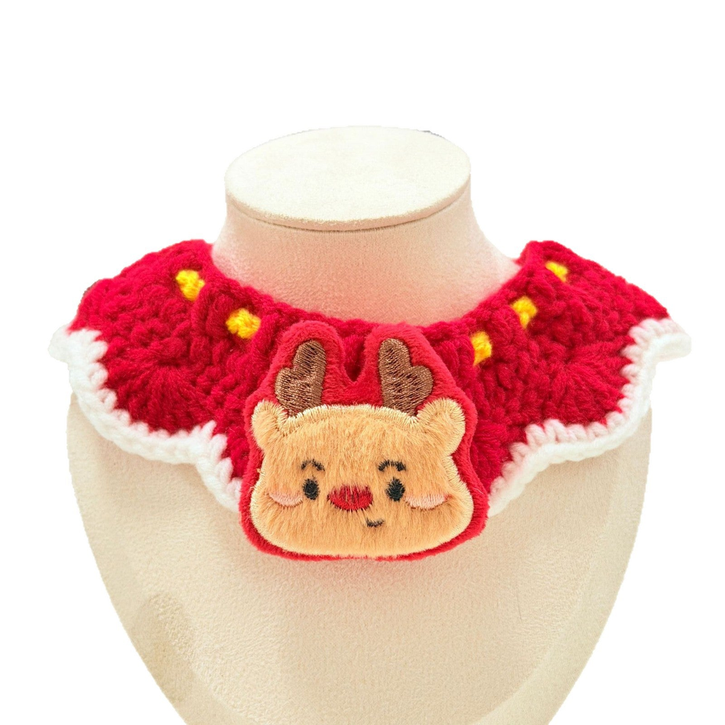 Red Reindeer pet neckwear with a reindeer-face appliqué and white scalloped edging on a cream display bust.