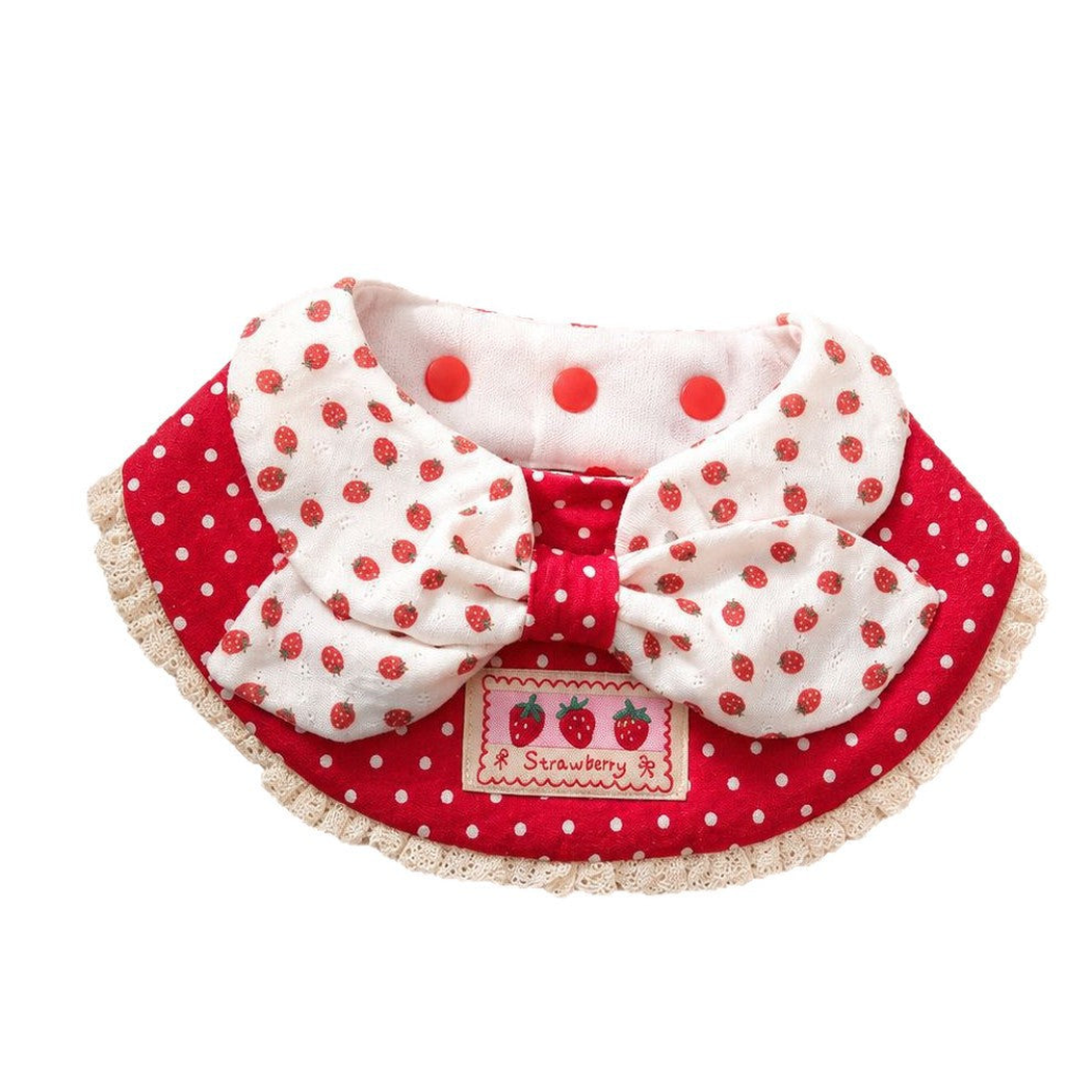 Red and white polka-dot pet neckwear with a strawberry-patterned bow and cream lace-look edge on a white background.