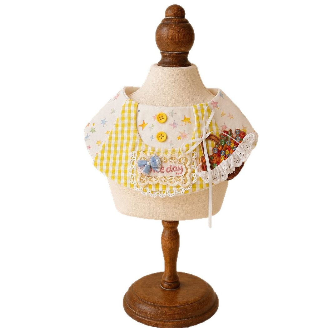 Yellow gingham and pastel star pet neckwear on a display stand, with bows, lace-look trim, and a flower basket appliqué.