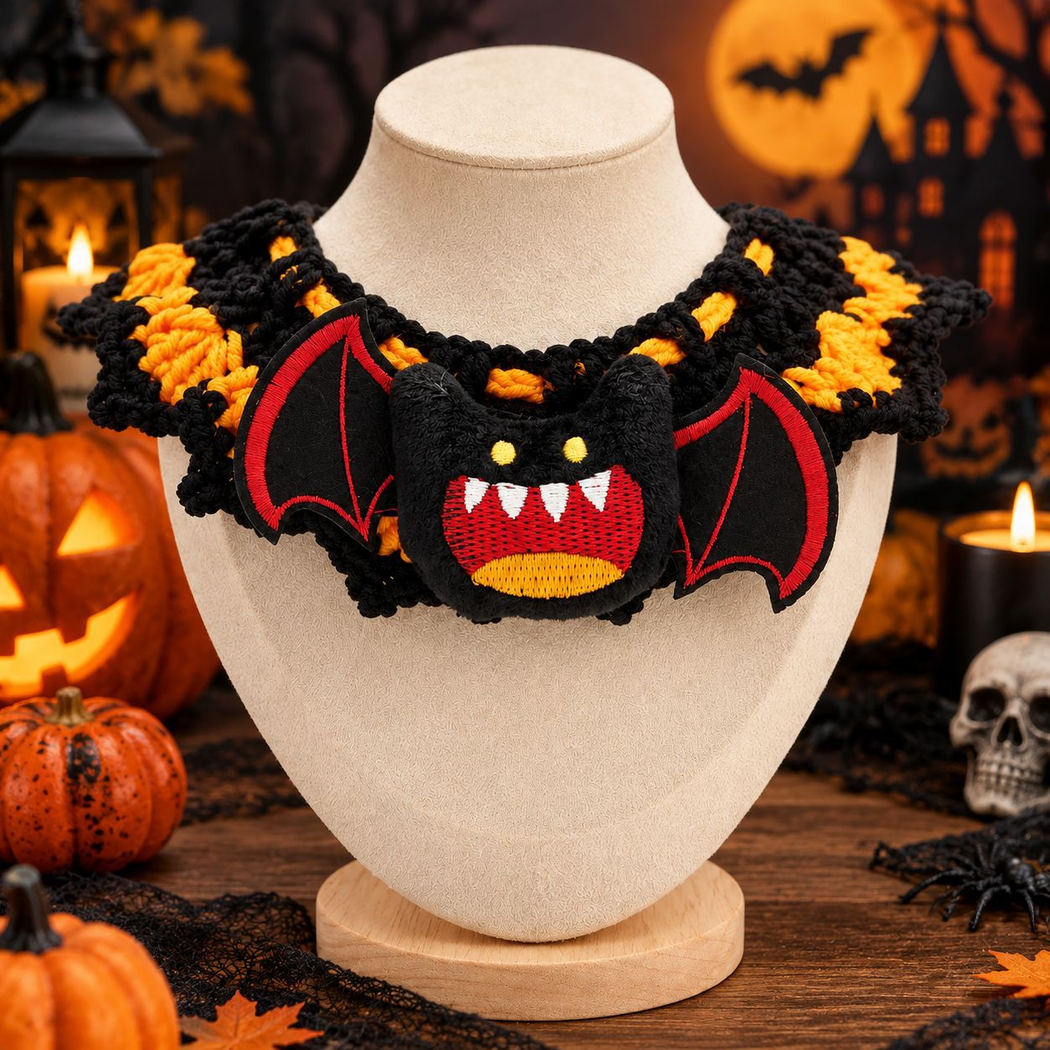 Spider-style black and orange pet neckwear with a fanged winged face