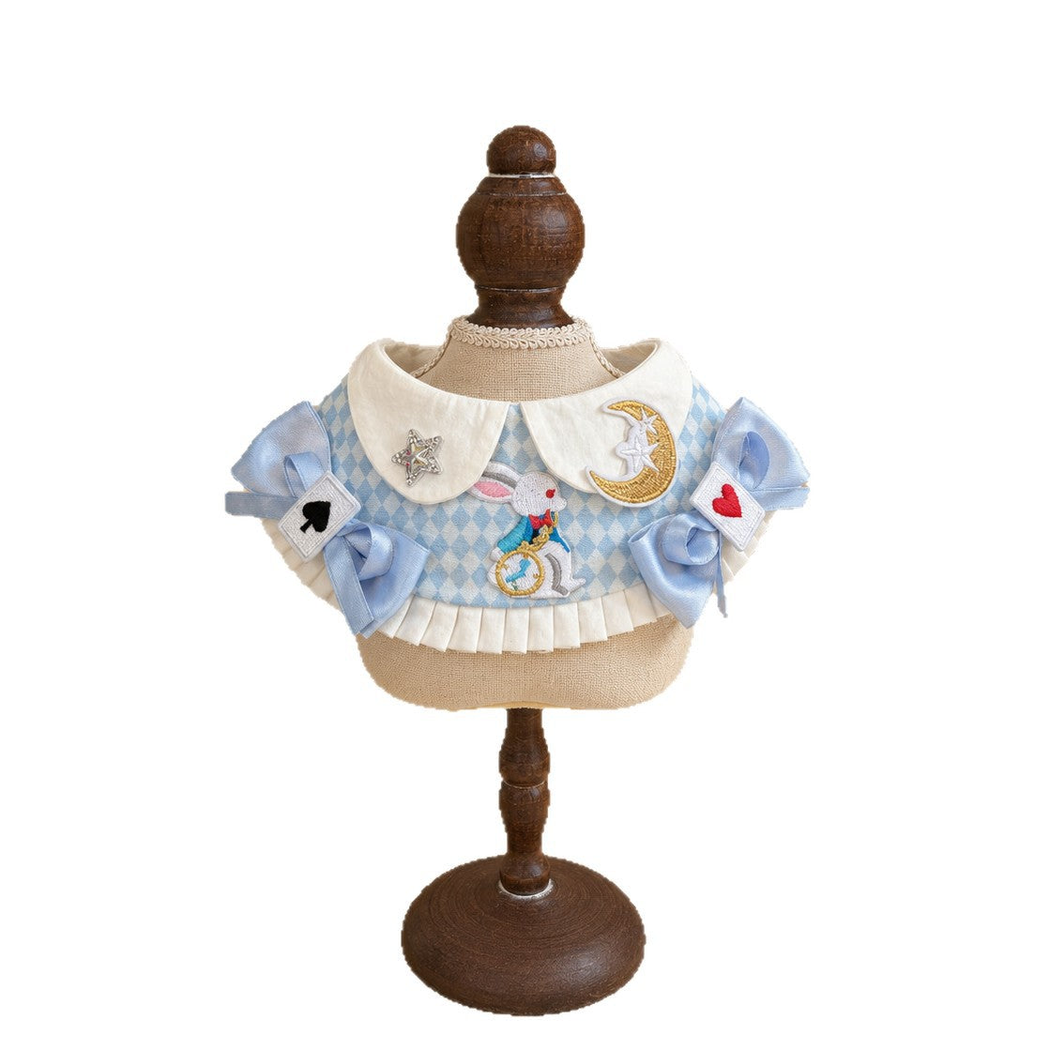 Multicolor bib-style pet neckwear with blue bows, rabbit, moon, and star motifs, front view