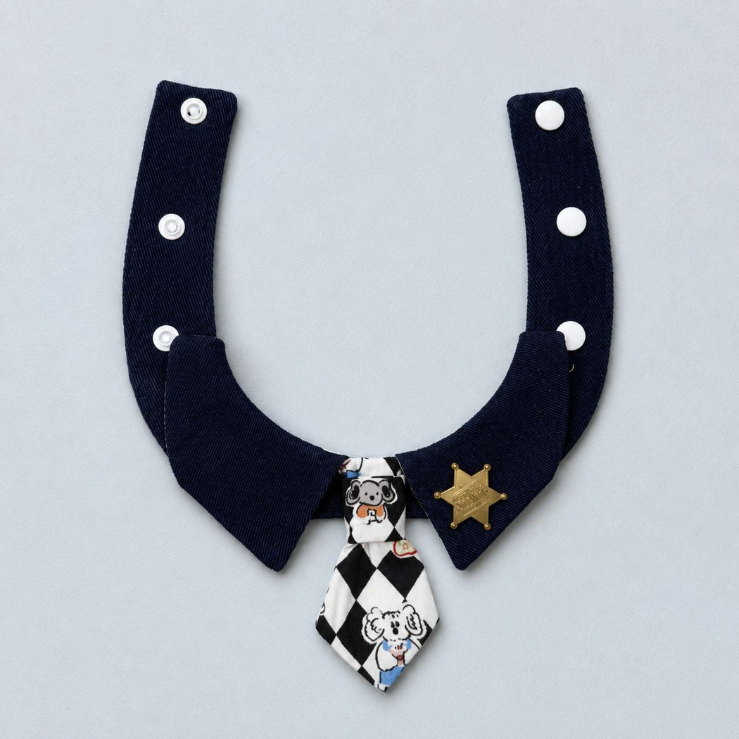 Pet neckwear with a checkerboard tie, snap fasteners, and sheriff-star badge, flat front view