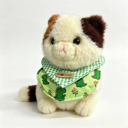 Dinosaur pet neckwear bib shown on a plush cat